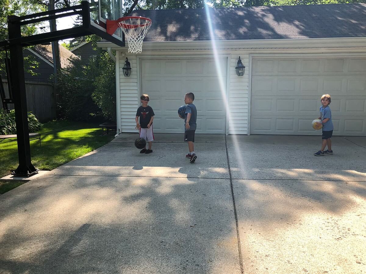 kids playing basketball on driveway