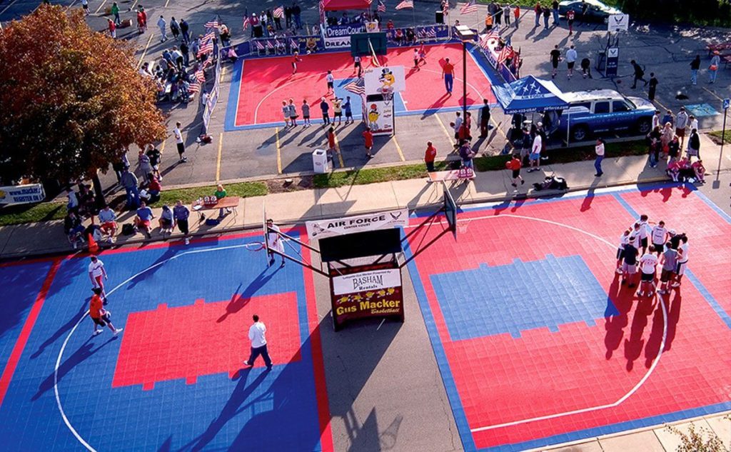 A basketball court with people playing on it.