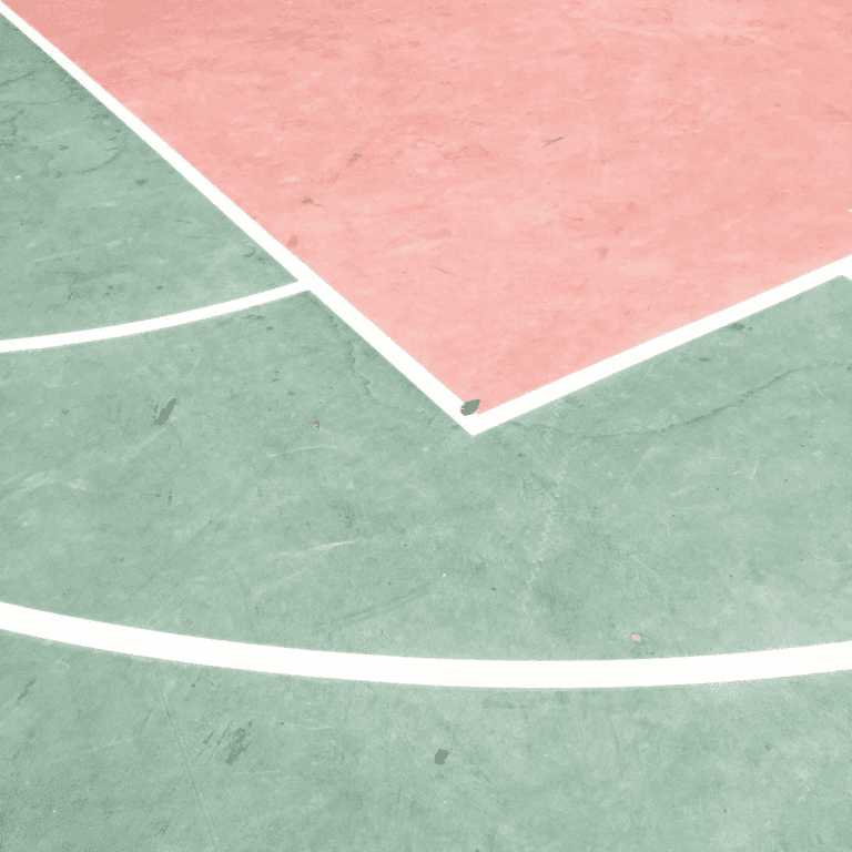 A weather-resistant outdoor basketball court with colorful pink and green lines.