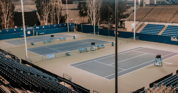 A tennis court in a stadium.